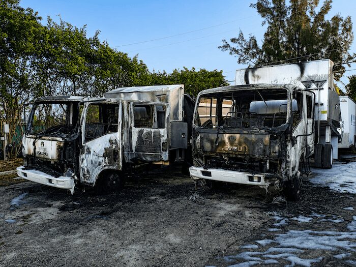 Two burned-out company trucks